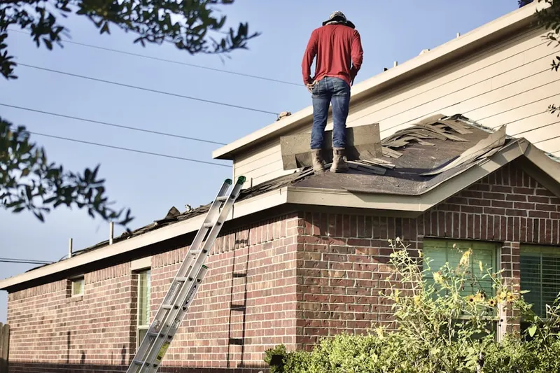 Professional roofer working on a residential roof in Staley